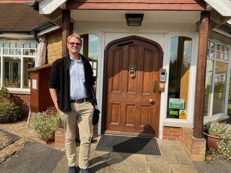 Dr stood outside Birtley House nursing home entrance door on a sunny day for regular weekly visit