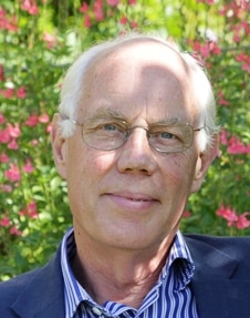 Headshot of Birtley House Nursing Home and Estate Chairman in blue blazer and blue and white stripped shirt and glasses